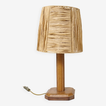 Lamp base in saddle stitched leather and raffia lampshade.