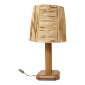 Lamp base in saddle stitched leather and raffia lampshade.
