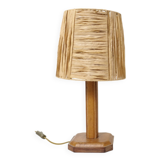 Lamp base in saddle stitched leather and raffia lampshade.