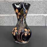 Black vase with yellow flowers