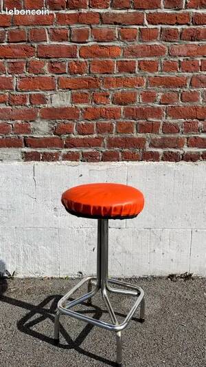 Vintage chrome stool with orange faux leather.
