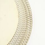 Mid Century Modern round wall mirror with a white expanded metal frame