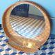 Vintage rattan wall mirror with glass shelf