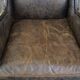 Black cow leather armchair finished with decorative nails, industrial style