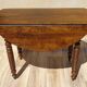 Walnut drop-leaf table with honey spoon legs.