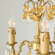 Small vintage brass chandelier with amber crystal pendants.
