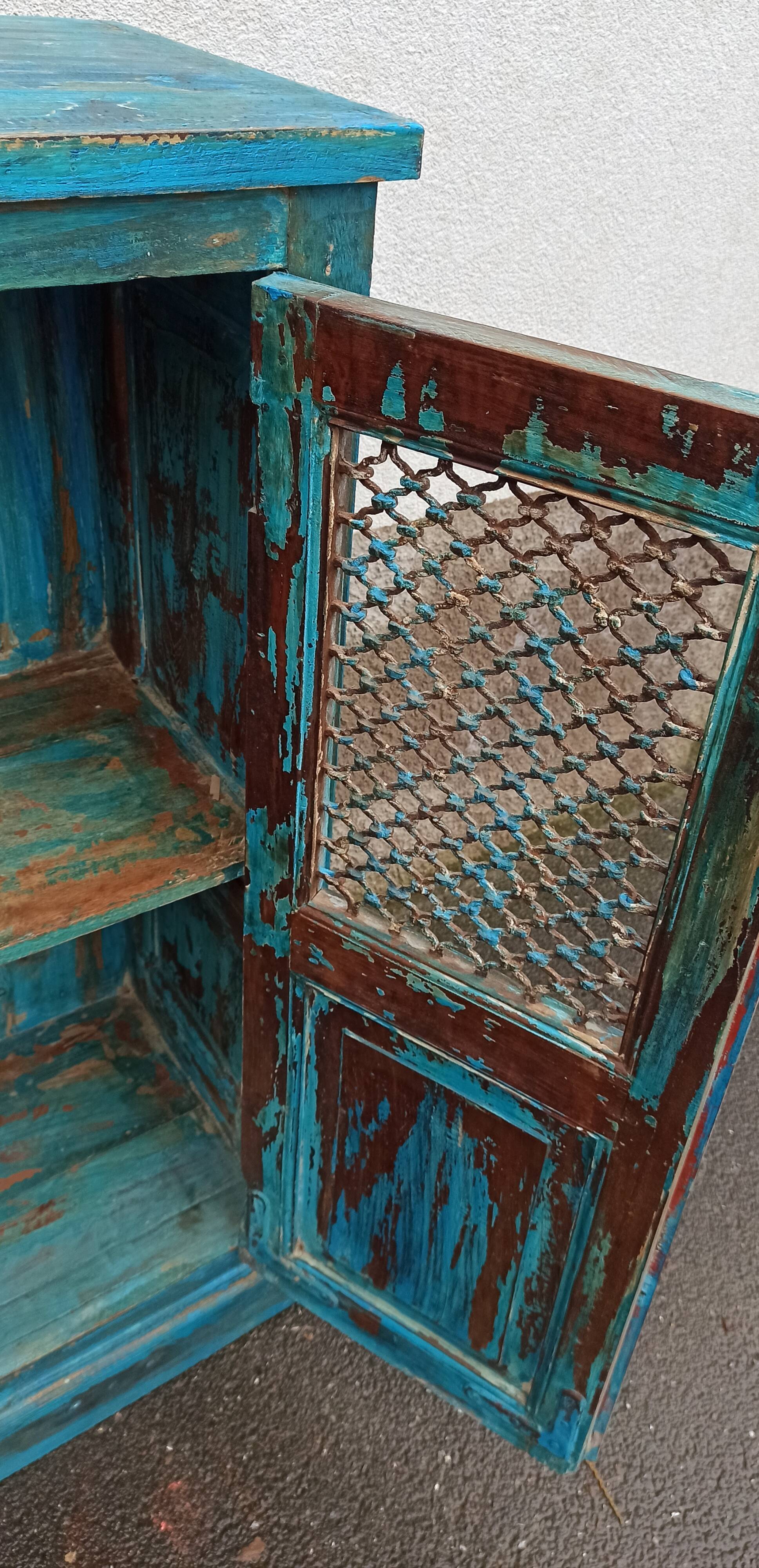 Old wooden cabinet with doors with grille