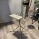Gold wrought iron ashtray on legs with magazine rack and marbled shelf