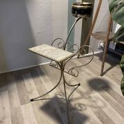 Gold wrought iron ashtray on legs with magazine rack and marbled shelf