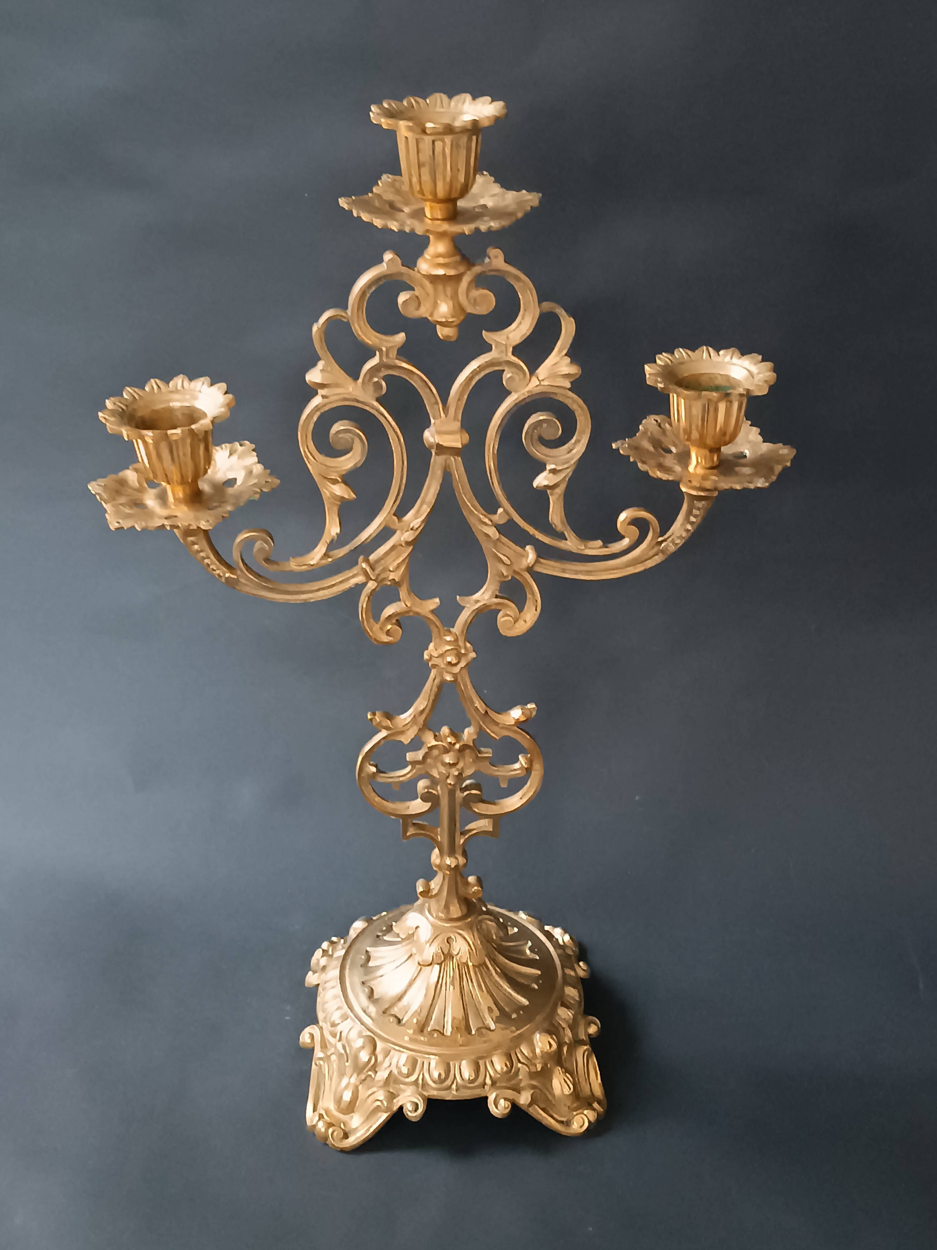 Antique three-light openwork brass church candelabrum.