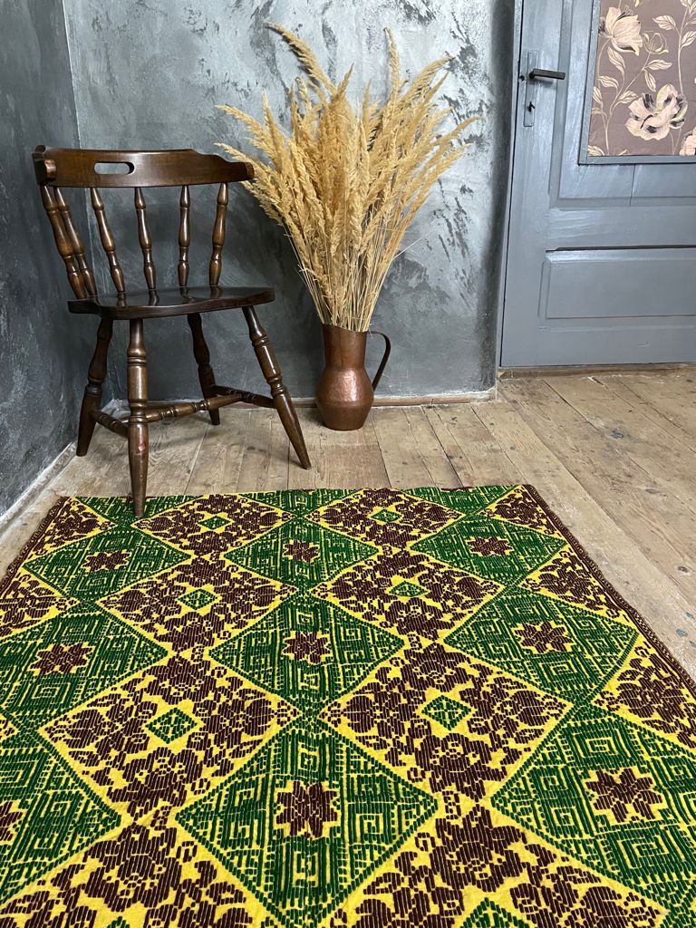 Green and yellow handmade rug with delicate colourful flowers