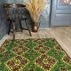 Green and yellow handmade rug with delicate colourful flowers