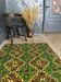Green and yellow handmade rug with delicate colourful flowers