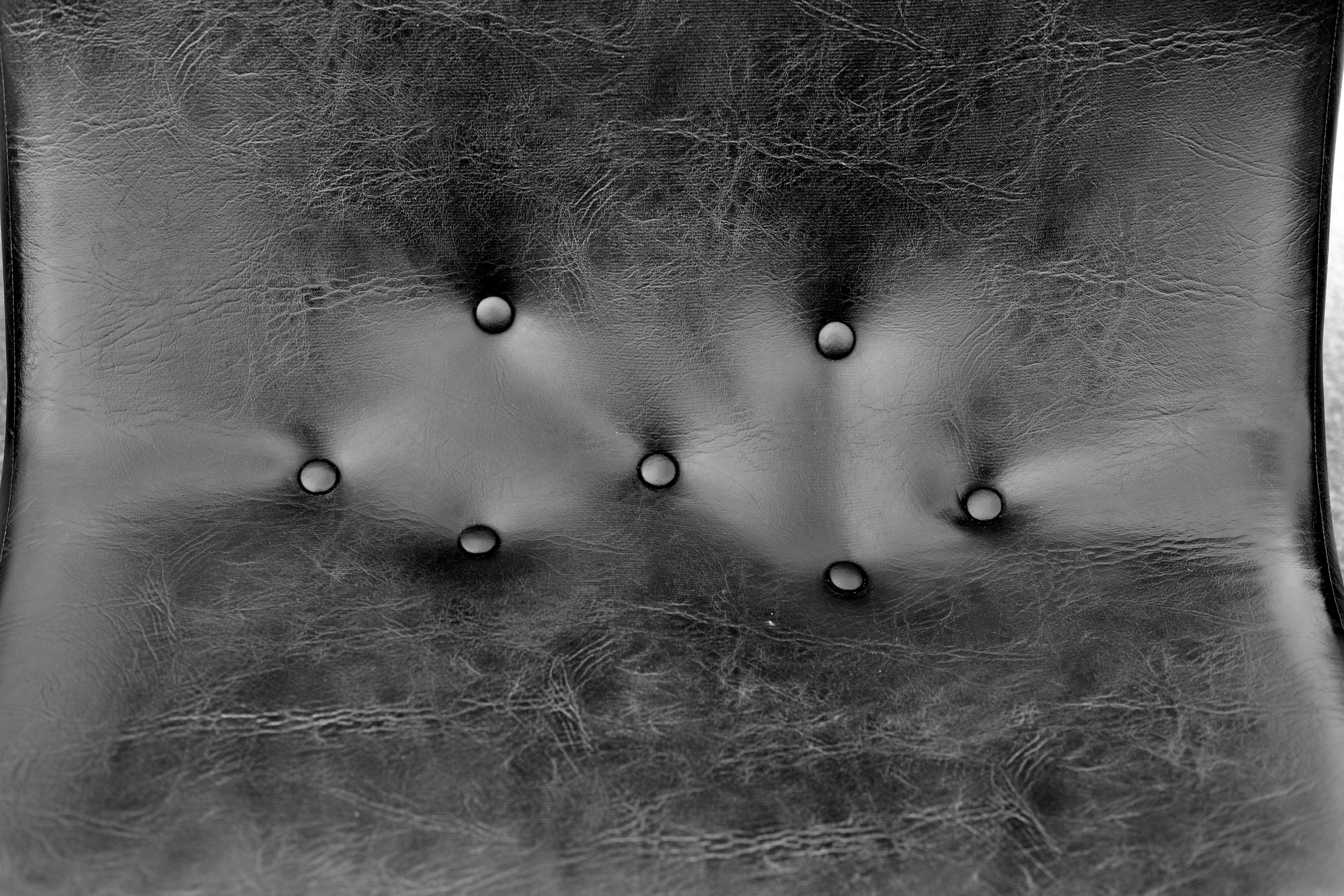 Pair of “space age” low chairs. Black faux leather. Circa 1970