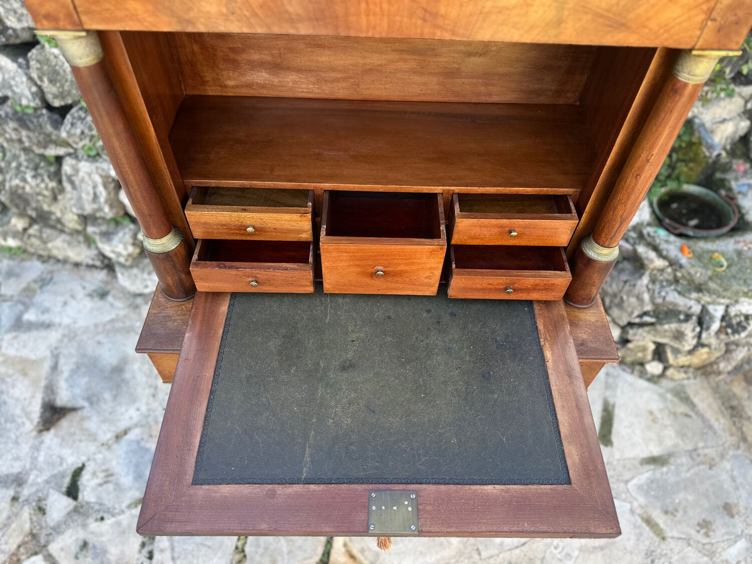 A small piece of Bonheur du jour with detached columns in Empire-era mahogany.
