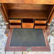 A small piece of Bonheur du jour with detached columns in Empire-era mahogany.