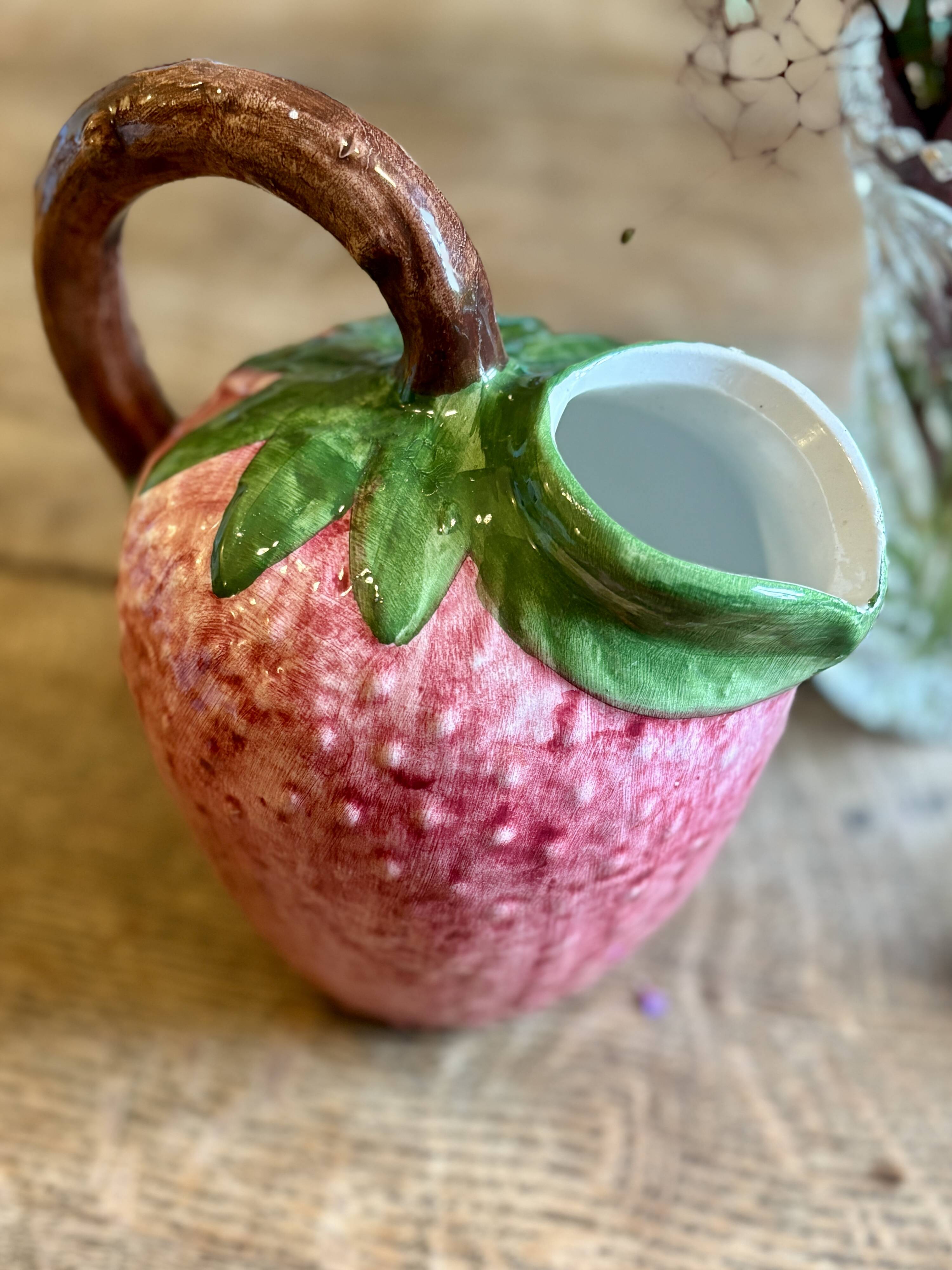 Ceramic jug in the shape of a strawberry.