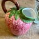Ceramic jug in the shape of a strawberry.