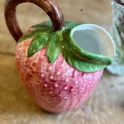 Ceramic jug in the shape of a strawberry.