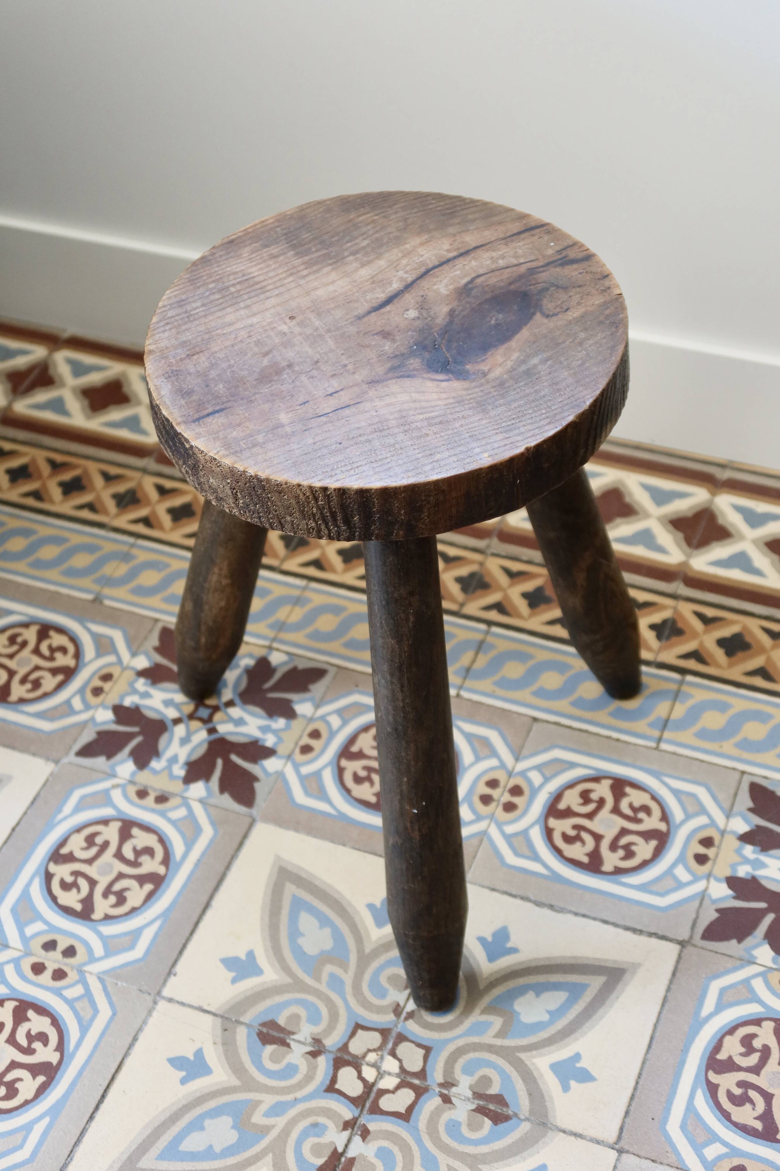 Old dark wood tripod stool