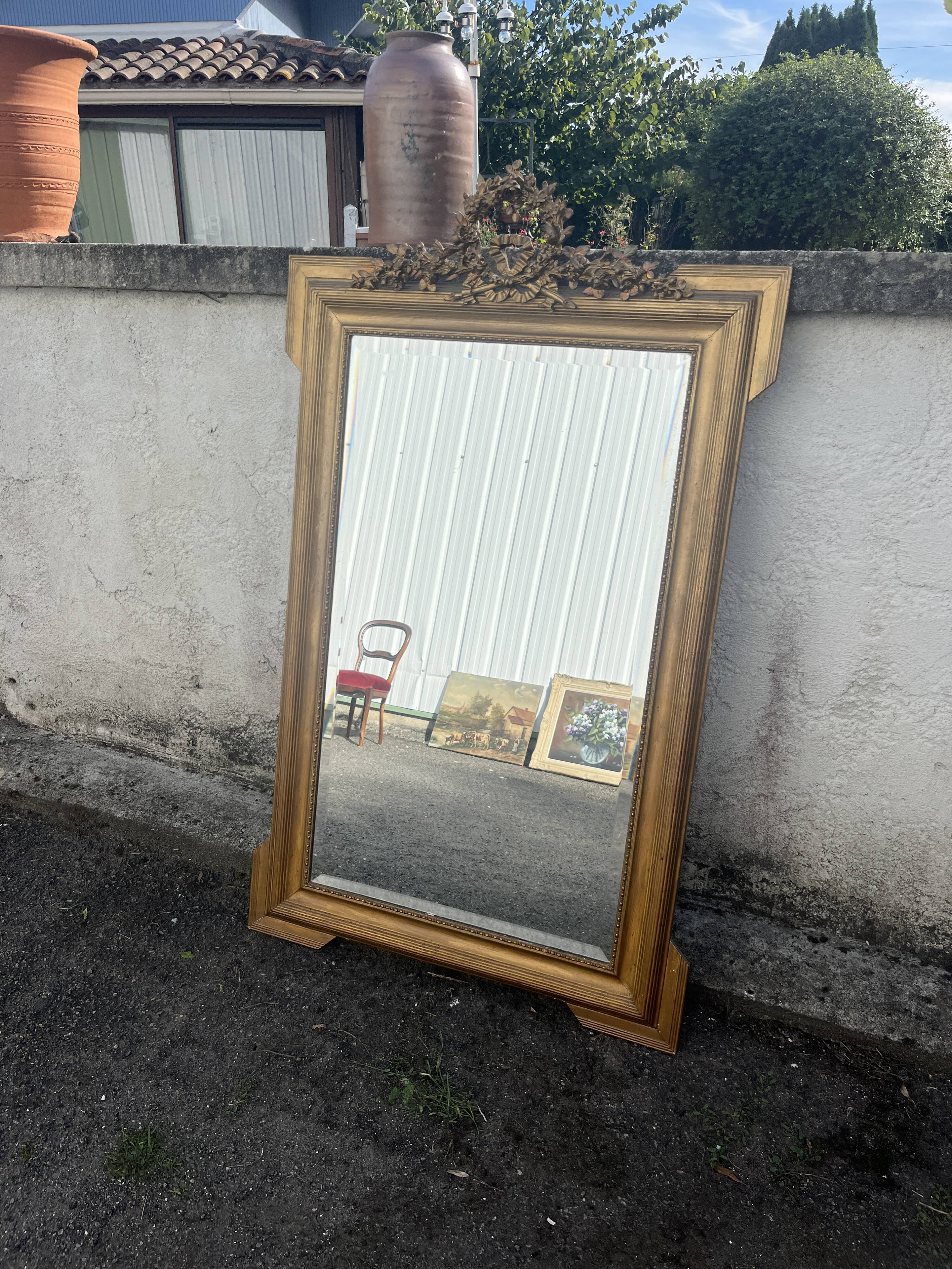 Large antique gilded mirror with carved pediment, 126 cm