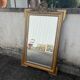 Large antique gilded mirror with carved pediment, 126 cm