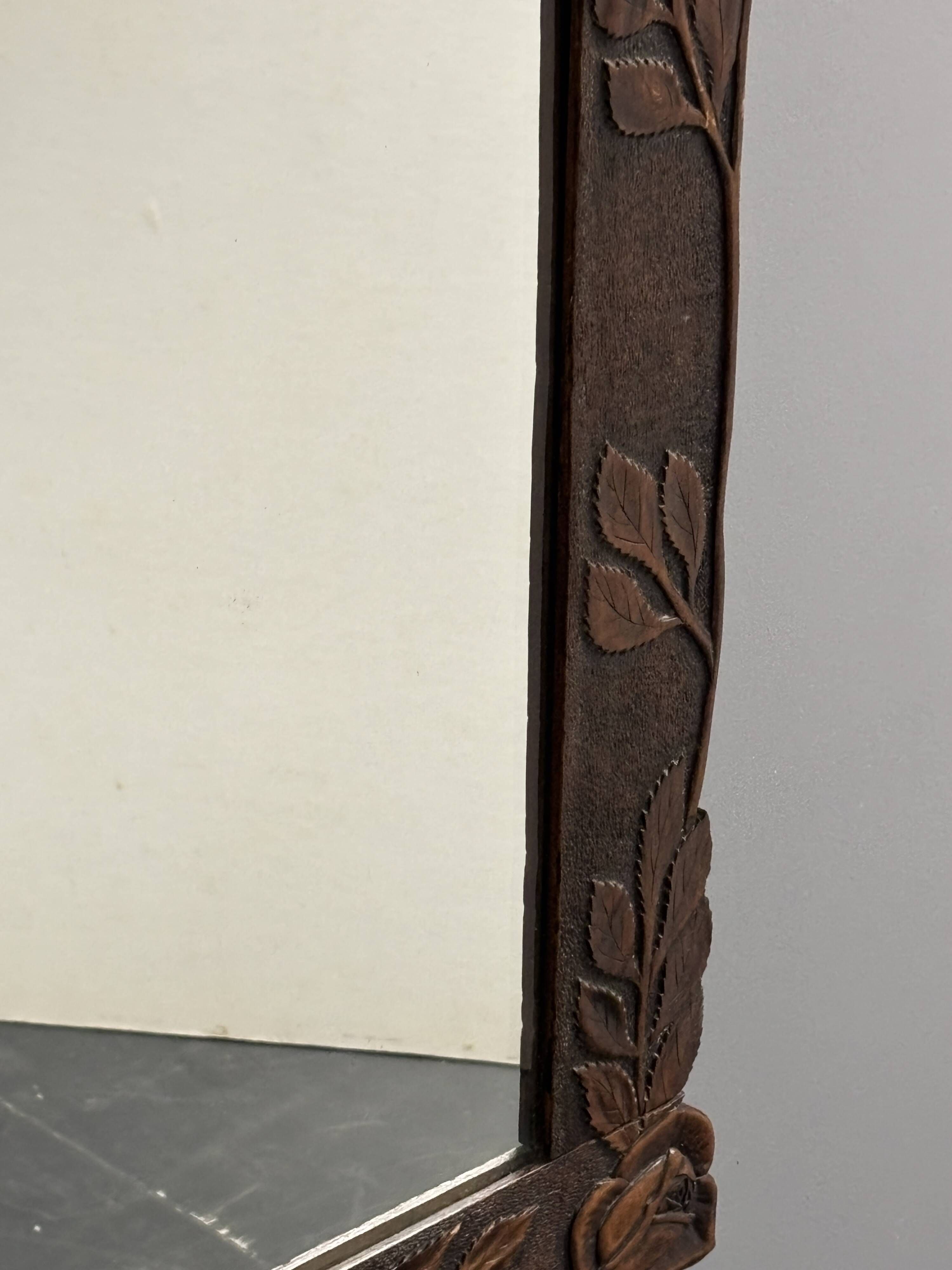 Arts & Crafts hand-carved wall mirror with floral roses, early 20th century