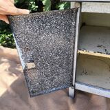 Small white and speckled gray industrial style enameled piece of furniture