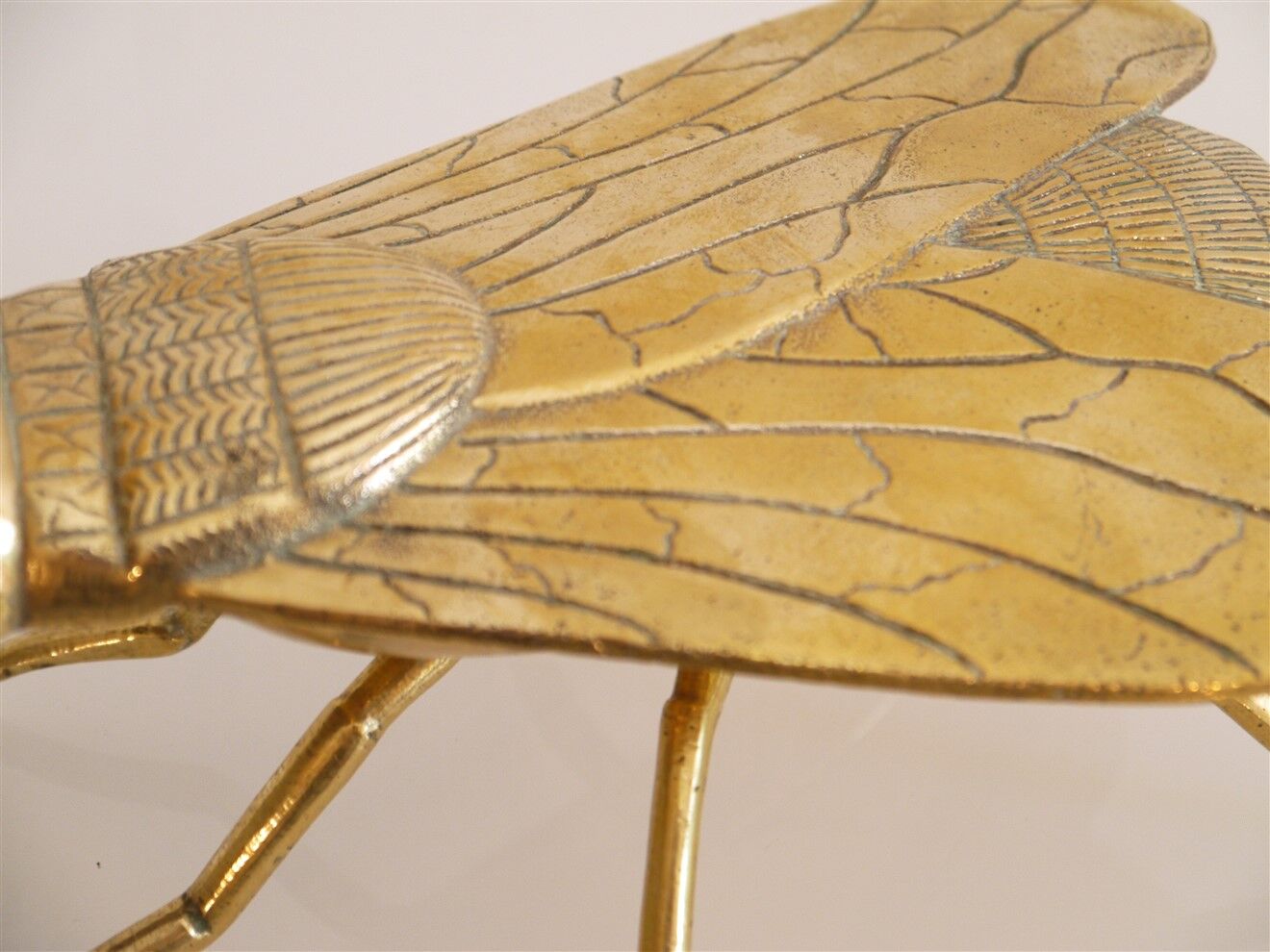 Empty vintage pocket in the shape of a brass insect