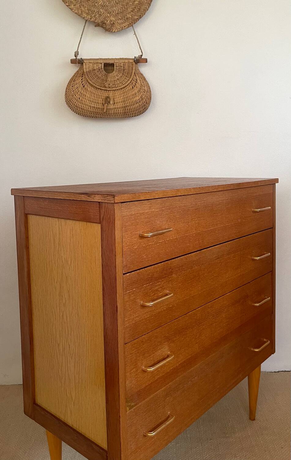 Vintage 1960s chest of drawers with covered handles.