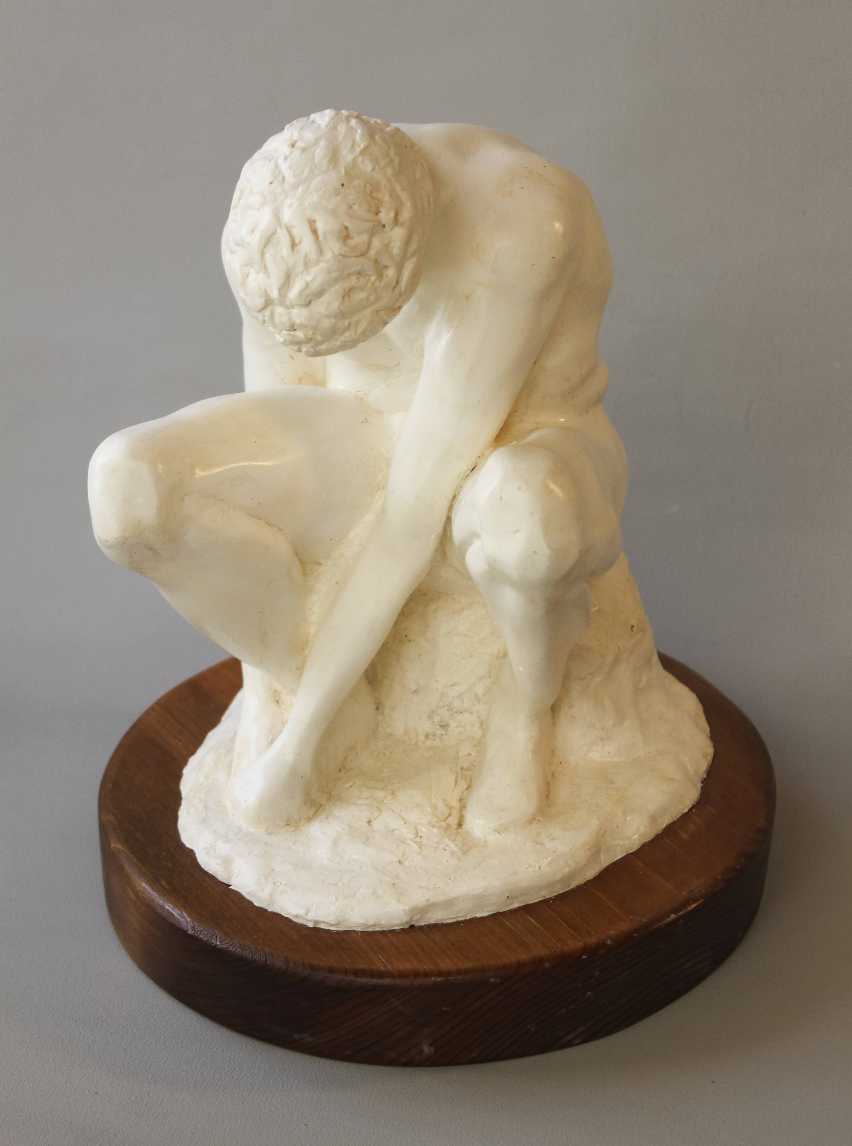 Sculpture of a seated man. Classical male sculpture. Male figure.