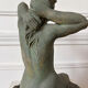Sculpture of a naked woman titled "Youth" in terracotta.