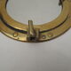 Mirror integrated into a brass navy porthole