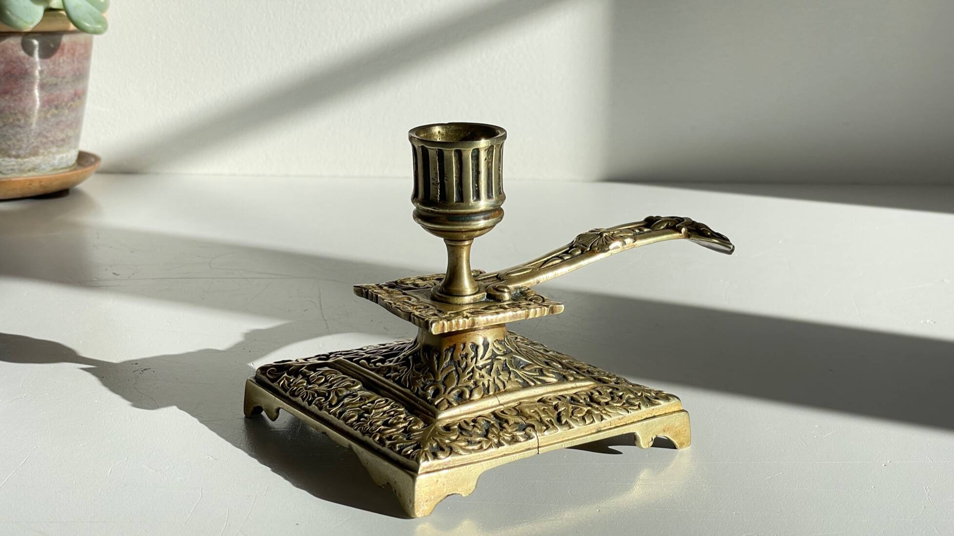 Patterned solid bronze hand candle holder