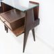 Pair of modernist Italian bedside tables in wood with a glass top.