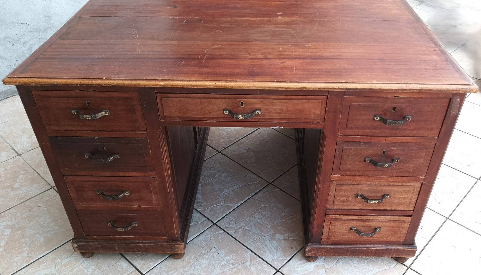 Vintage double-sided mahogany desk with 18 drawers.