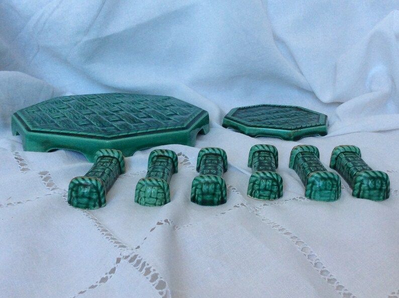 Set of 6 knife holders, a trivet, a 1960s bottle coaster