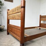 Brutalist style bed with chain and straw
