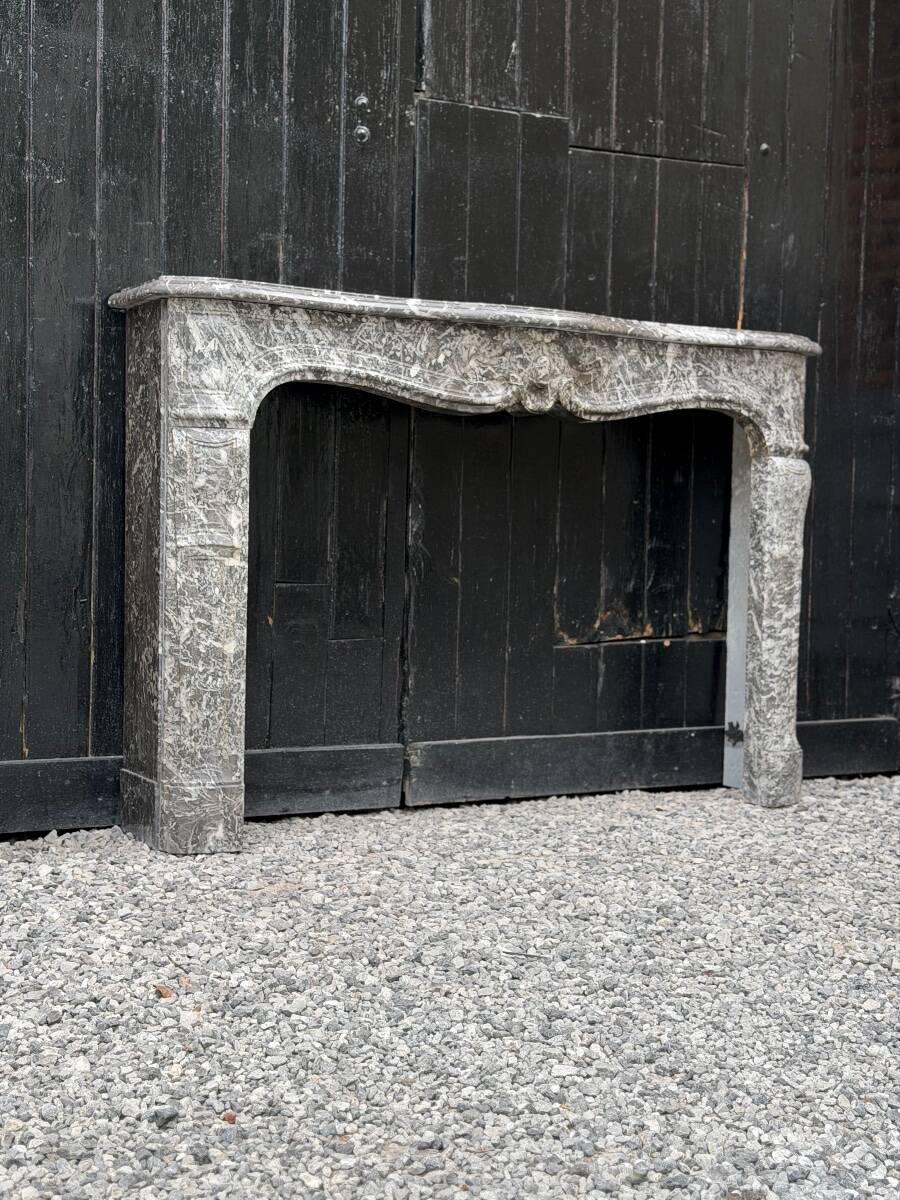 Louis XV fireplace in grey Saint Anne marble, 18th century.