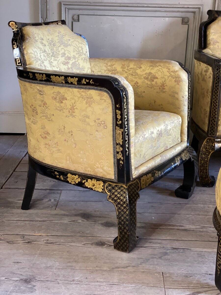 A set of two armchairs, a sofa and two poufs in lacquered wood with gilded chinoiserie decoration.