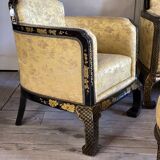 A set of two armchairs, a sofa and two poufs in lacquered wood with gilded chinoiserie decoration.