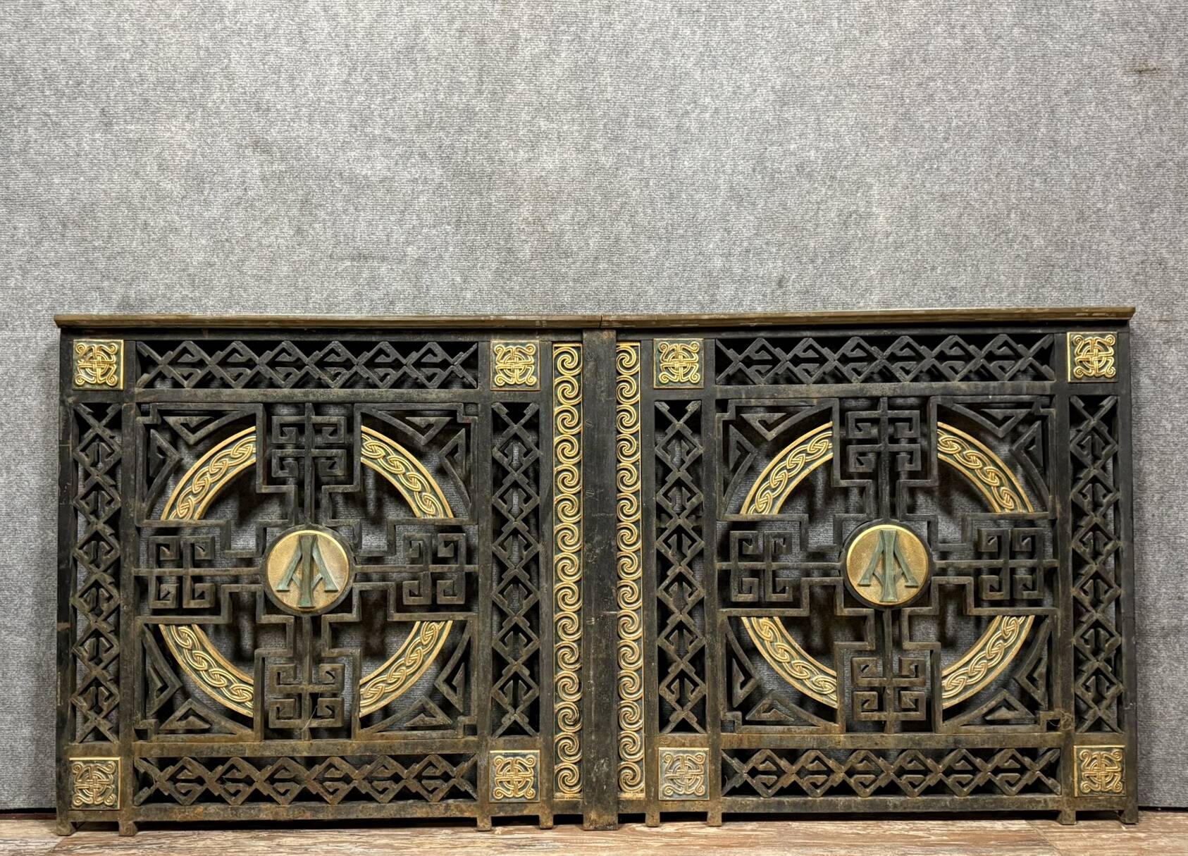 pair of monogrammed cast iron doors from the Art Deco period