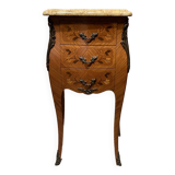 Wooden bedside table topped with a pink marble top