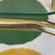 Pair of small nesting coffee tables in gold tubular metal & transparent glass tops