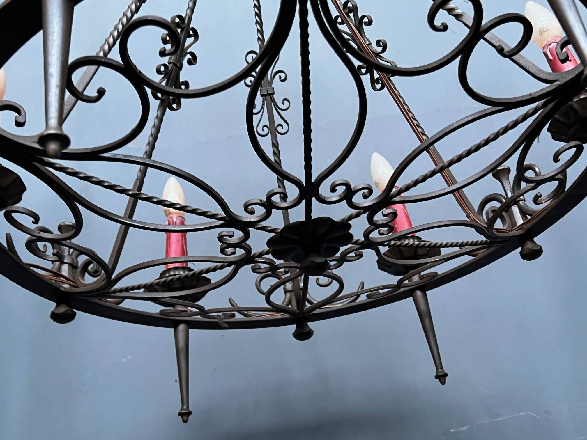 Wrought chandelier in Gothic style.