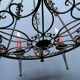 Wrought chandelier in Gothic style.