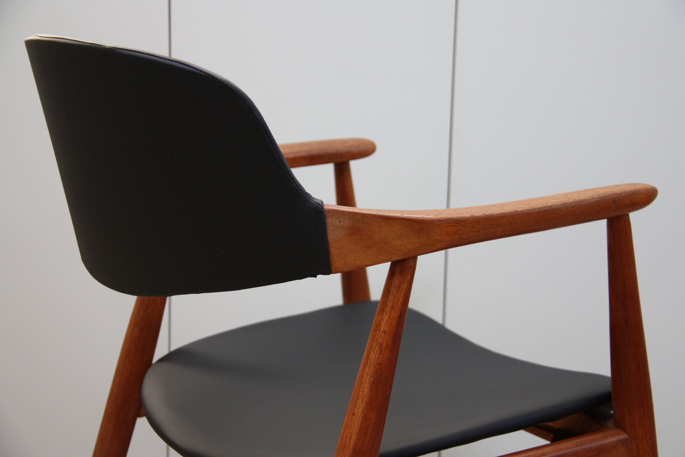 Vintage armchair in teak and black leather model Casina 60s