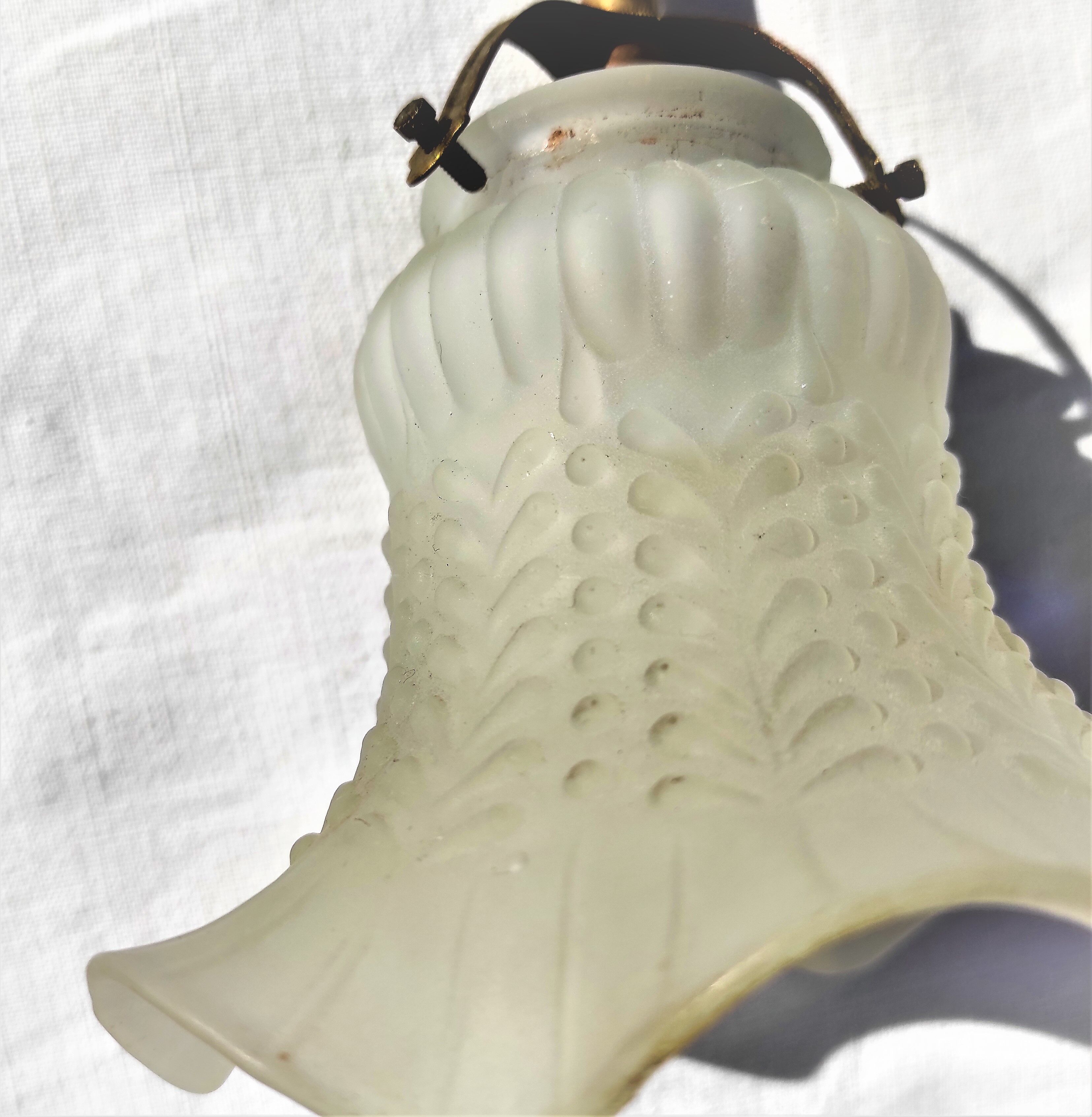 Brass gooseneck wall lamp, with brass socket and porcelain base.