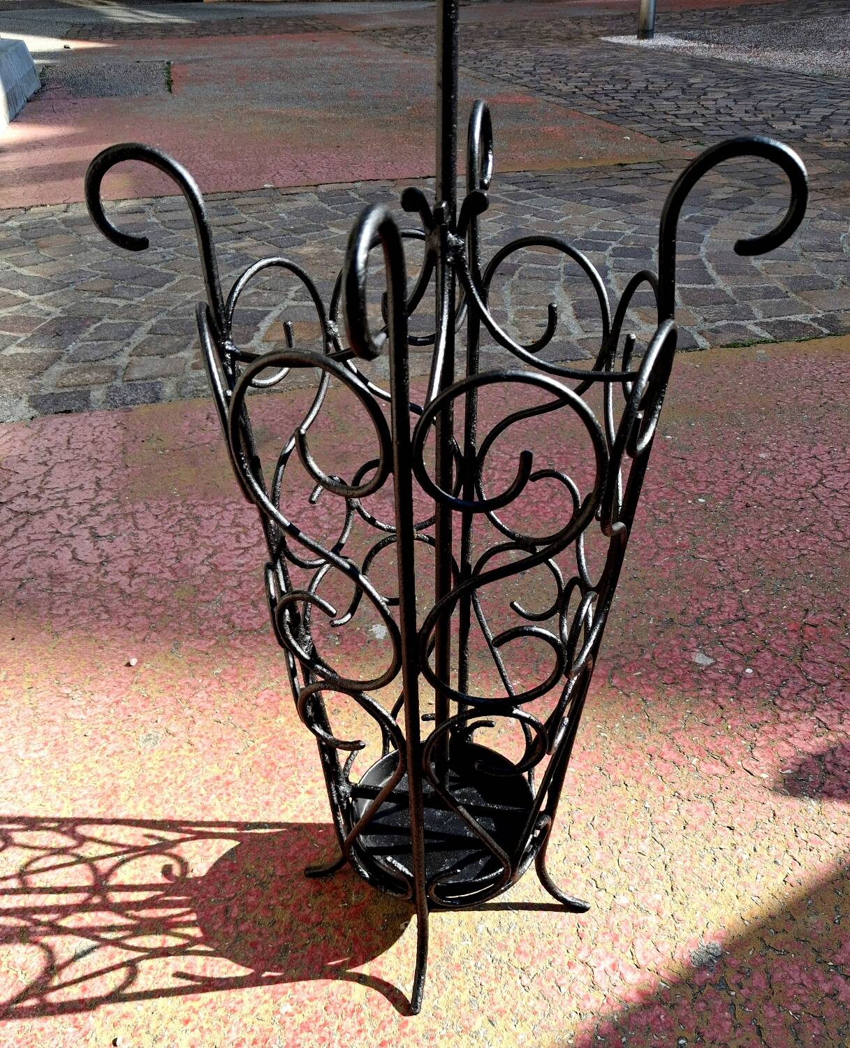 Antique wrought iron umbrella stand for entrance hall, vintage decor.