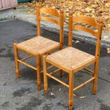 2 straw-seated chairs in light-colored solid wood
